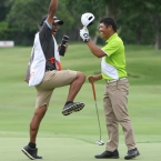 1champion jay bayron with his caddie jump for joy after he hole out the champion ball